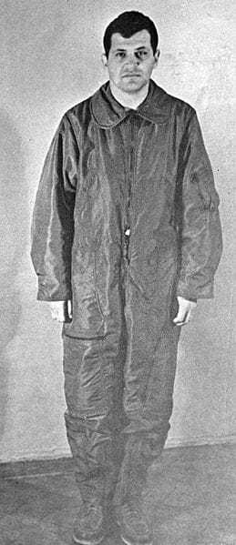 A black and white photograph of Gary in a baggy Soviet prison uniform.